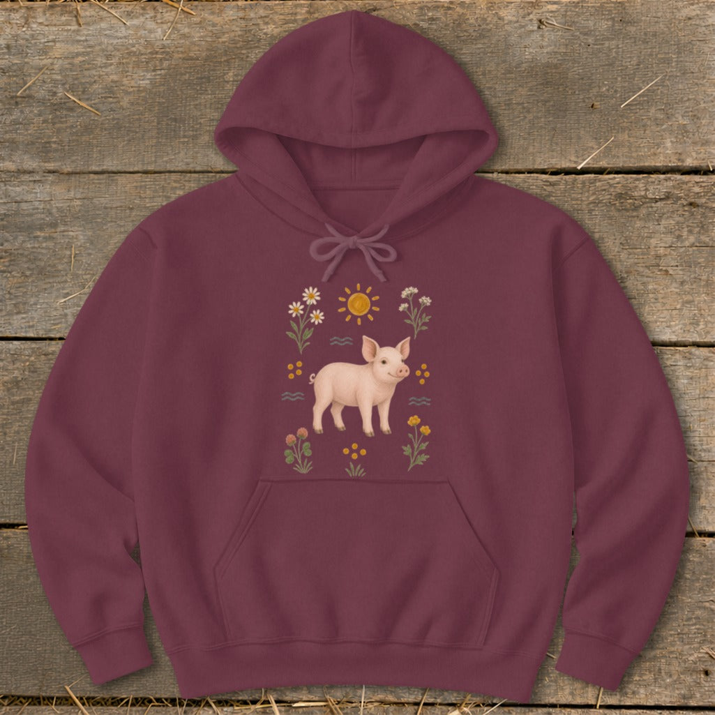 Maroon hoodie with a pink pig, sun, and wildflowers graphic on the front.