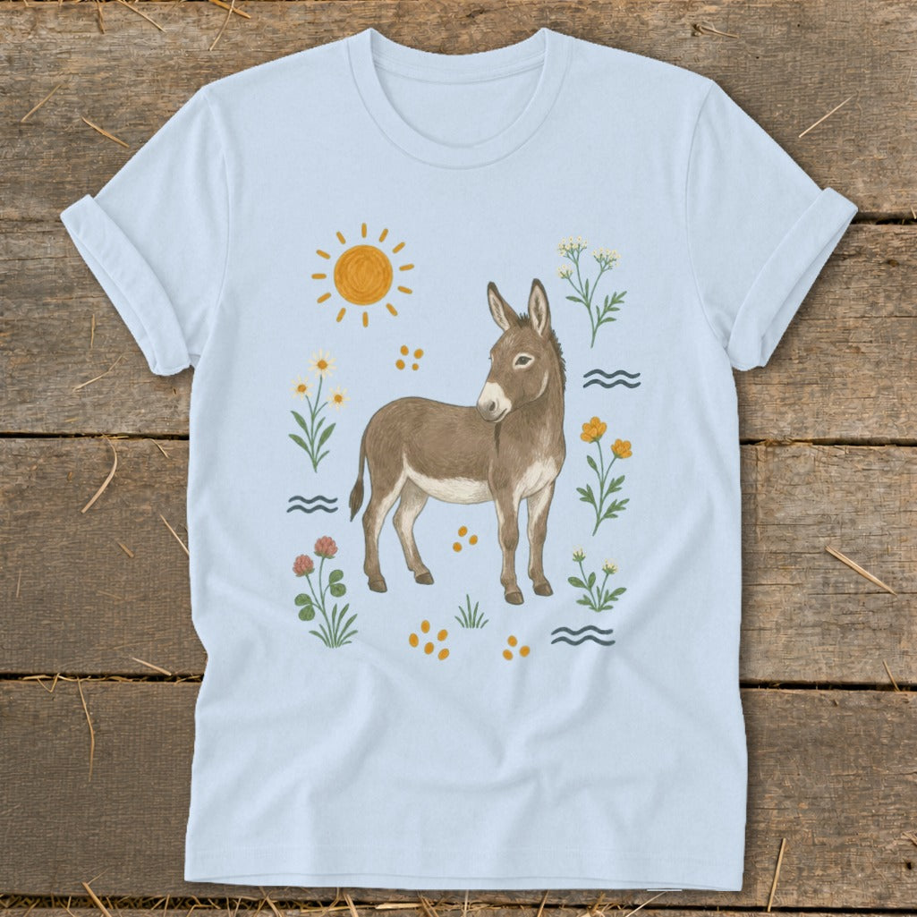 Light blue t-shirt with a donkey illustration surrounded by sun, flowers, and waves.