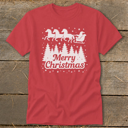 Red t-shirt with white Christmas graphic of horses pulling Santa's sleigh over trees and "Merry Christmas" text.