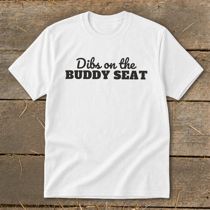White t-shirt with black text reading "Dibs on the BUDDY SEAT".