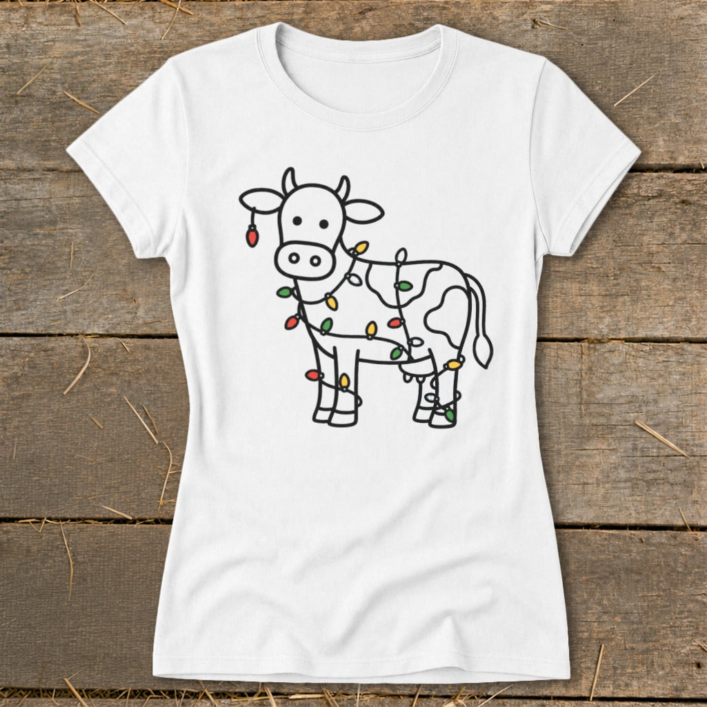 White t-shirt with black outline drawing of a cow adorned with colorful Christmas lights.