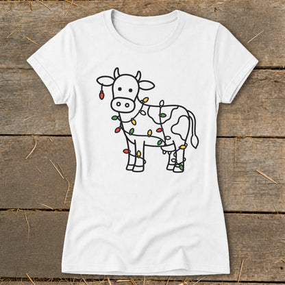 White t-shirt with black outline drawing of a cow adorned with colorful Christmas lights.
