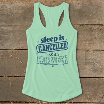 Mint green racerback tank top with navy text reading "sleep is CANCELLED it's FAIR WEEK".