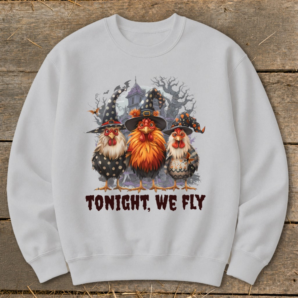 Three chickens in witch hats on white sweatshirt with "TONIGHT, WE FLY" text.