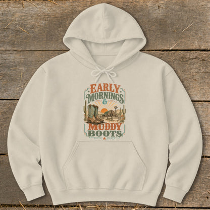 Cream hoodie with "Early Mornings & Muddy Boots" graphic featuring cowboy boots and a farm scene.