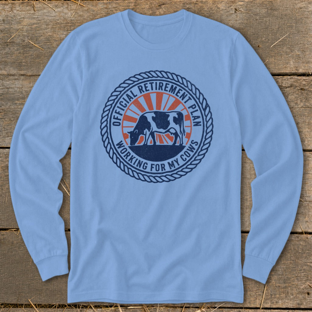 Blue long-sleeve shirt with circular graphic of cow and text "Official Retirement Plan Working For My Cows".