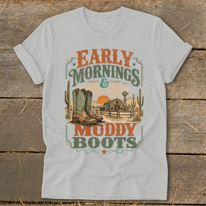 Grey t-shirt with "Early Mornings & Muddy Boots" text, cowboy boots, and barn scene.