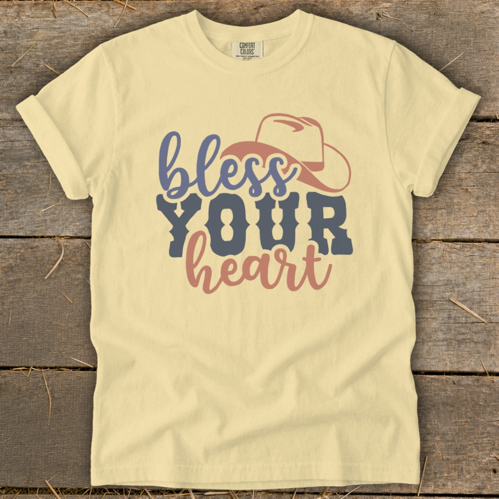 Yellow t-shirt with "bless YOUR heart" text and a cowboy hat graphic.