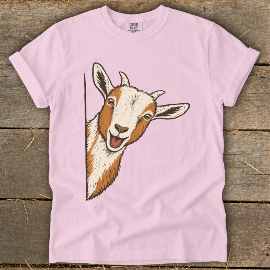 Pink t-shirt with a graphic of a peeking goat.