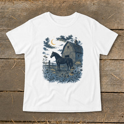 Black horse stands in a field of flowers beside a barn under a crescent moon.
