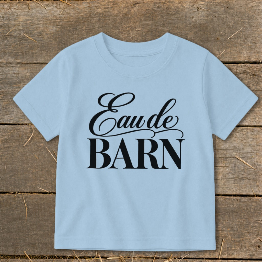 Light blue t-shirt with black text "Eau de BARN" in script and block lettering.