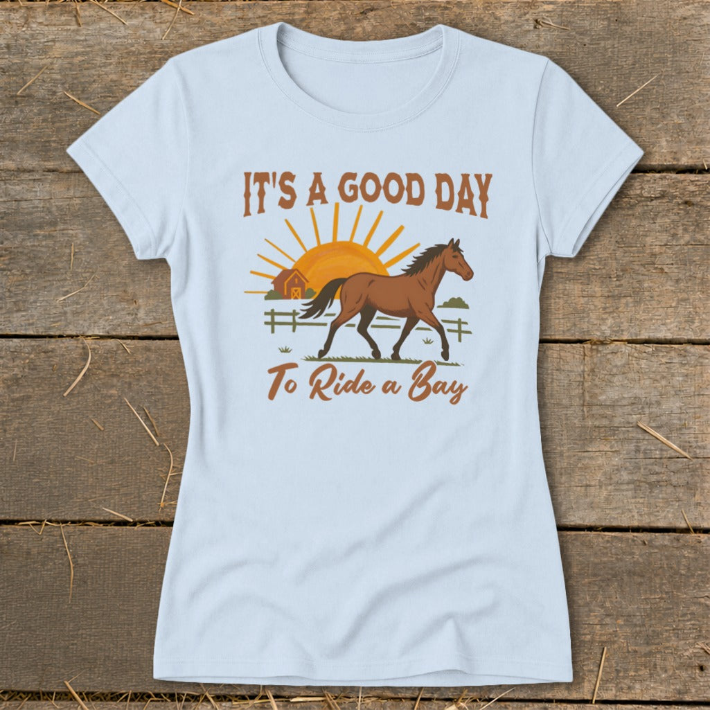 Light blue t-shirt with "It's a good day to ride a bay" text, horse, barn, and sun graphic.