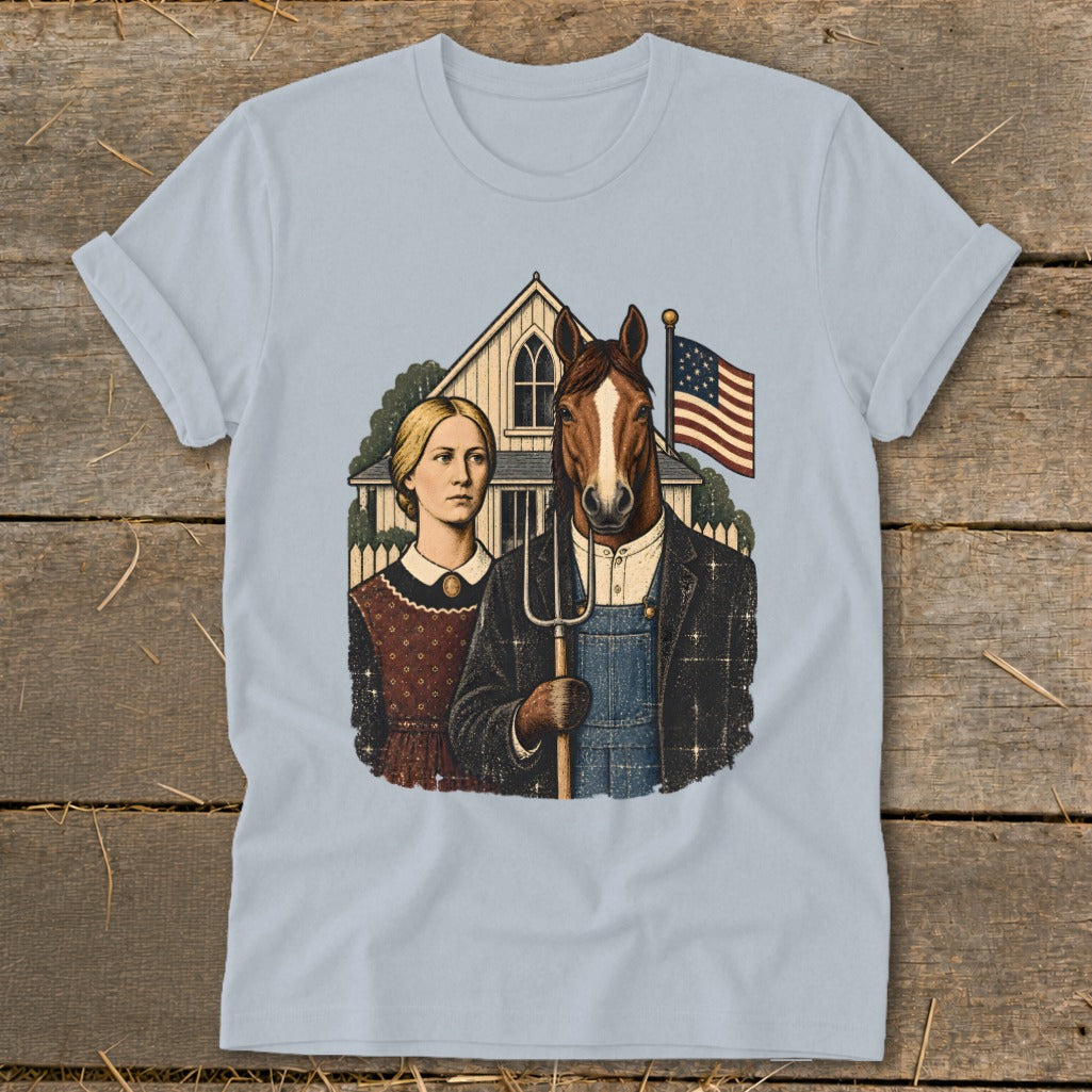 A light blue t-shirt printed with a parody of American Gothic featuring a woman and a horse-headed farmer holding a pitchfork.