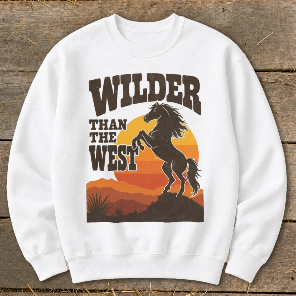 White sweatshirt with "WILDER THAN THE WEST" text and a rearing horse graphic.