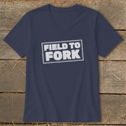 A navy blue V-neck t-shirt with a white rectangular border enclosing the text "FIELD TO FORK."