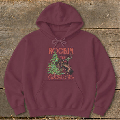 Burgundy hoodie with "Rockin' around the Christmas Tree" text and a cowboy on a bucking horse graphic.