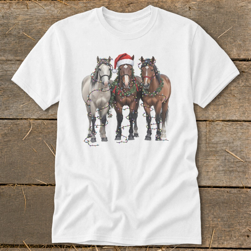 Three horses wearing Christmas wreaths and lights, one with a Santa hat.