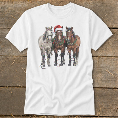 Three horses wearing Christmas wreaths and lights, one with a Santa hat.