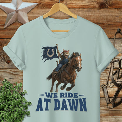 Cat cowboy riding horse with flag, "We Ride At Dawn" text.