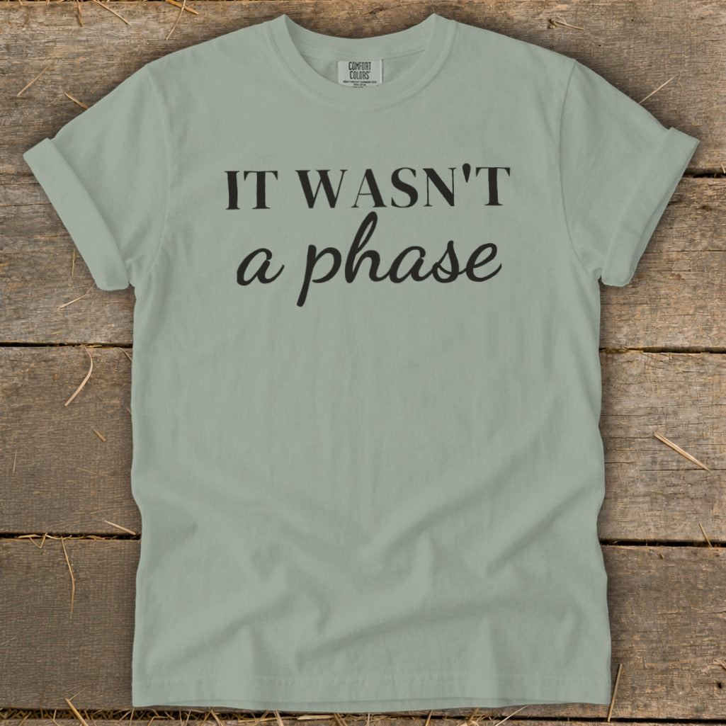 Light green t-shirt with black text reading "IT WASN'T a phase".