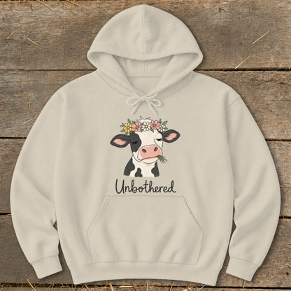Light beige hoodie with a cow wearing a flower crown and the text "Unbothered".