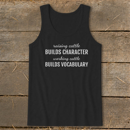 Black tank top with white text: "raising cattle BUILDS CHARACTER, working cattle BUILDS VOCABULARY."