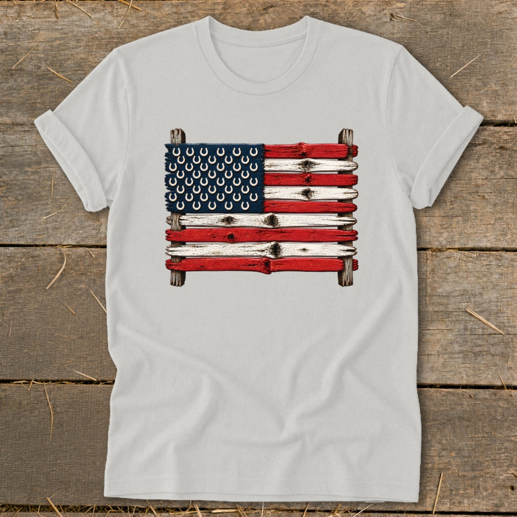 Light gray t-shirt featuring a rustic American flag graphic made of weathered wood planks with horseshoes.