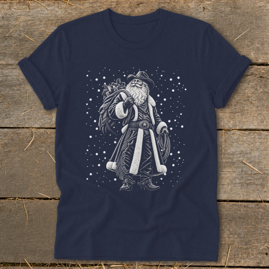 Cowboy Santa with sack and lasso, set against a starry background on a navy t-shirt.