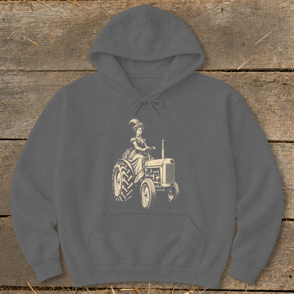 Line art of woman in vintage dress driving a tractor on a gray hoodie.