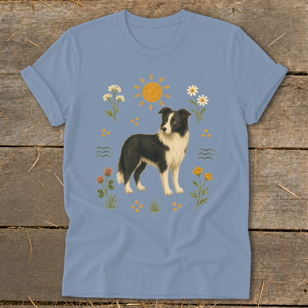 Light blue t-shirt with illustration of a Border Collie surrounded by flowers and a sun.