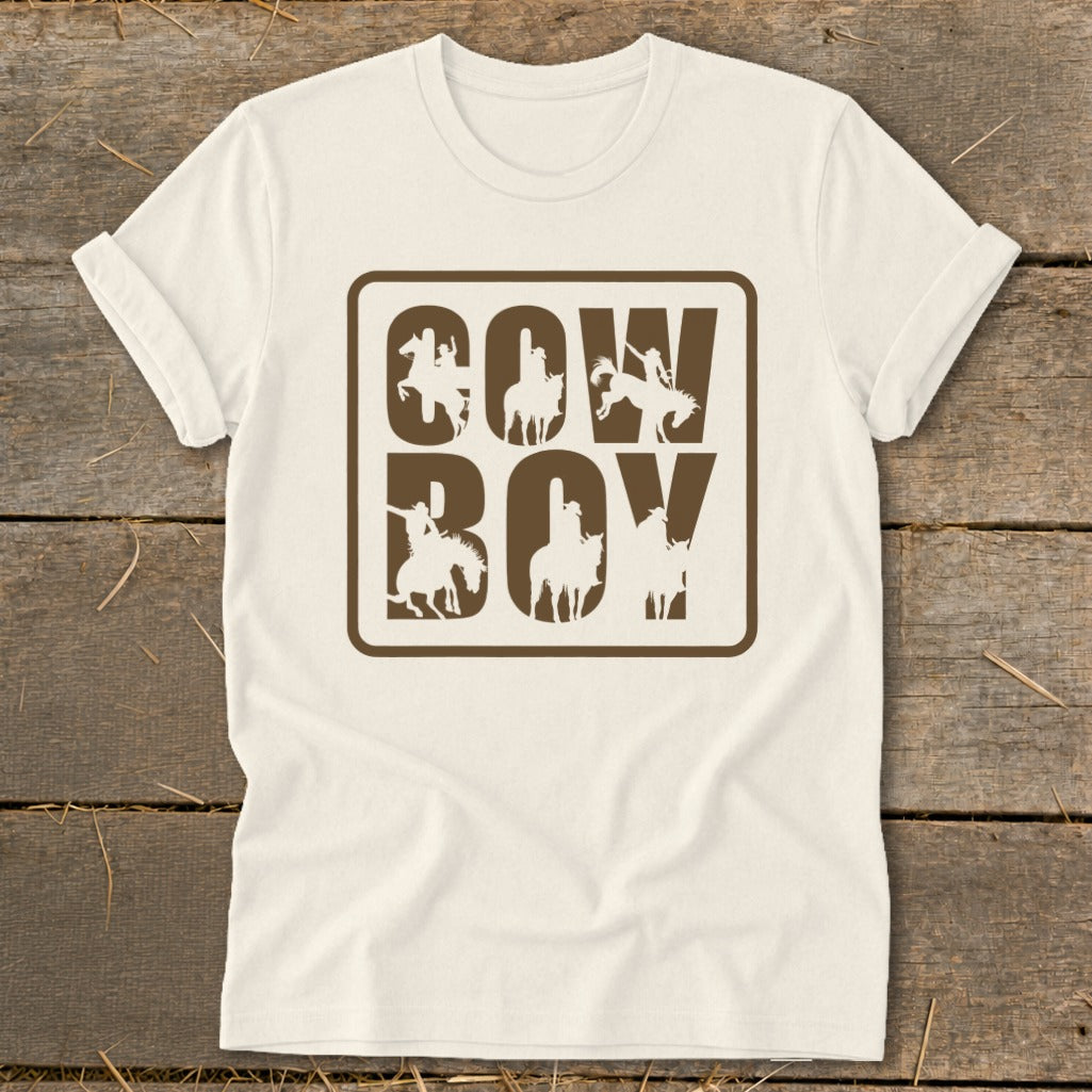 White t-shirt with brown "Cowboy" text formed by cowboy silhouettes on horses.