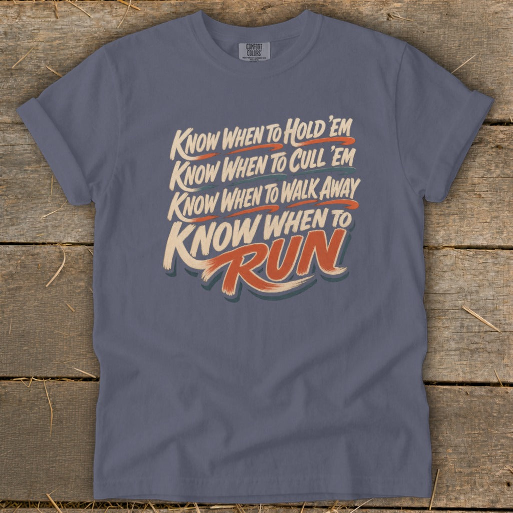 Slate blue t-shirt with "Know when to hold 'em, know when to cull 'em, know when to walk away, know when to Run" text.