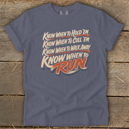 Slate blue t-shirt with "Know when to hold 'em, know when to cull 'em, know when to walk away, know when to Run" text.