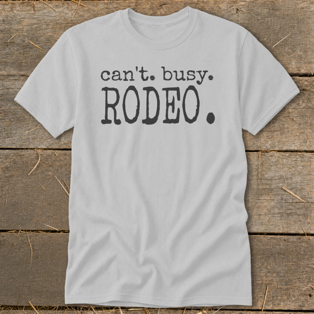 Light gray t-shirt with "can't. busy. RODEO." graphic in black distressed font.