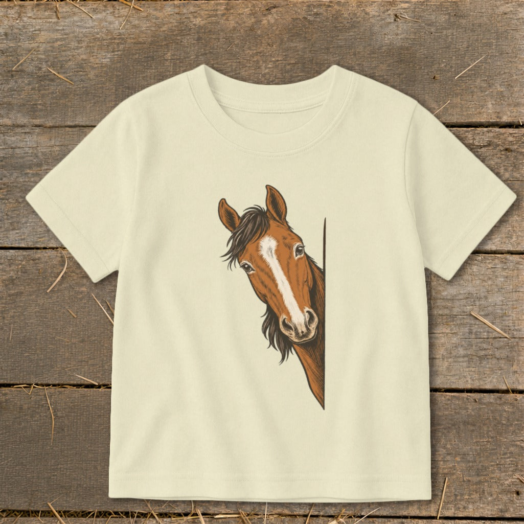 Cream t-shirt with a brown horse peeking from the side.