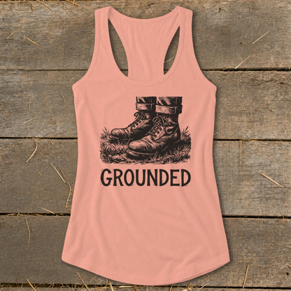 Peach tank top with illustration of boots in grass and "GROUNDED" text.
