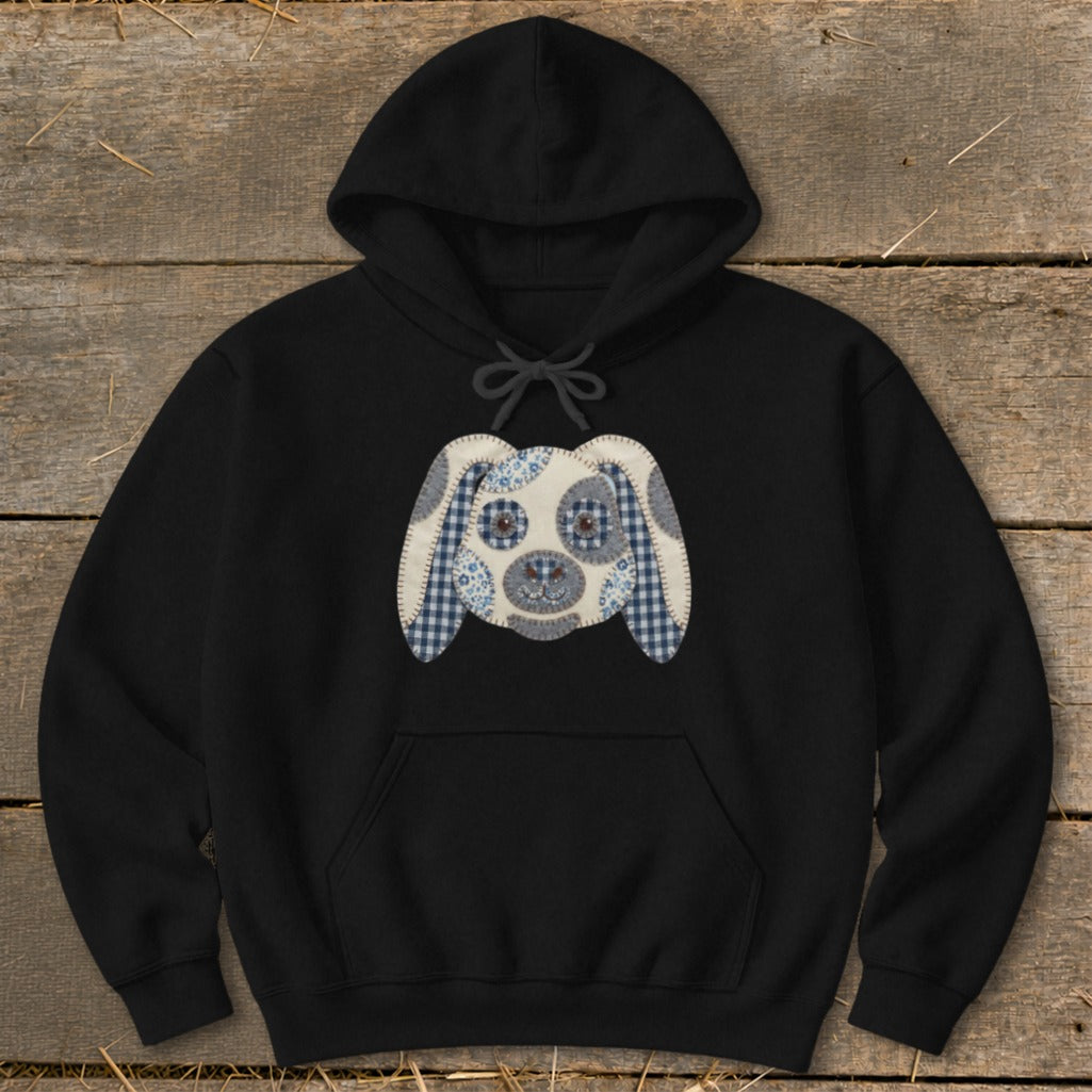 Black hoodie with a fabric applique of a dog's face on the front.
