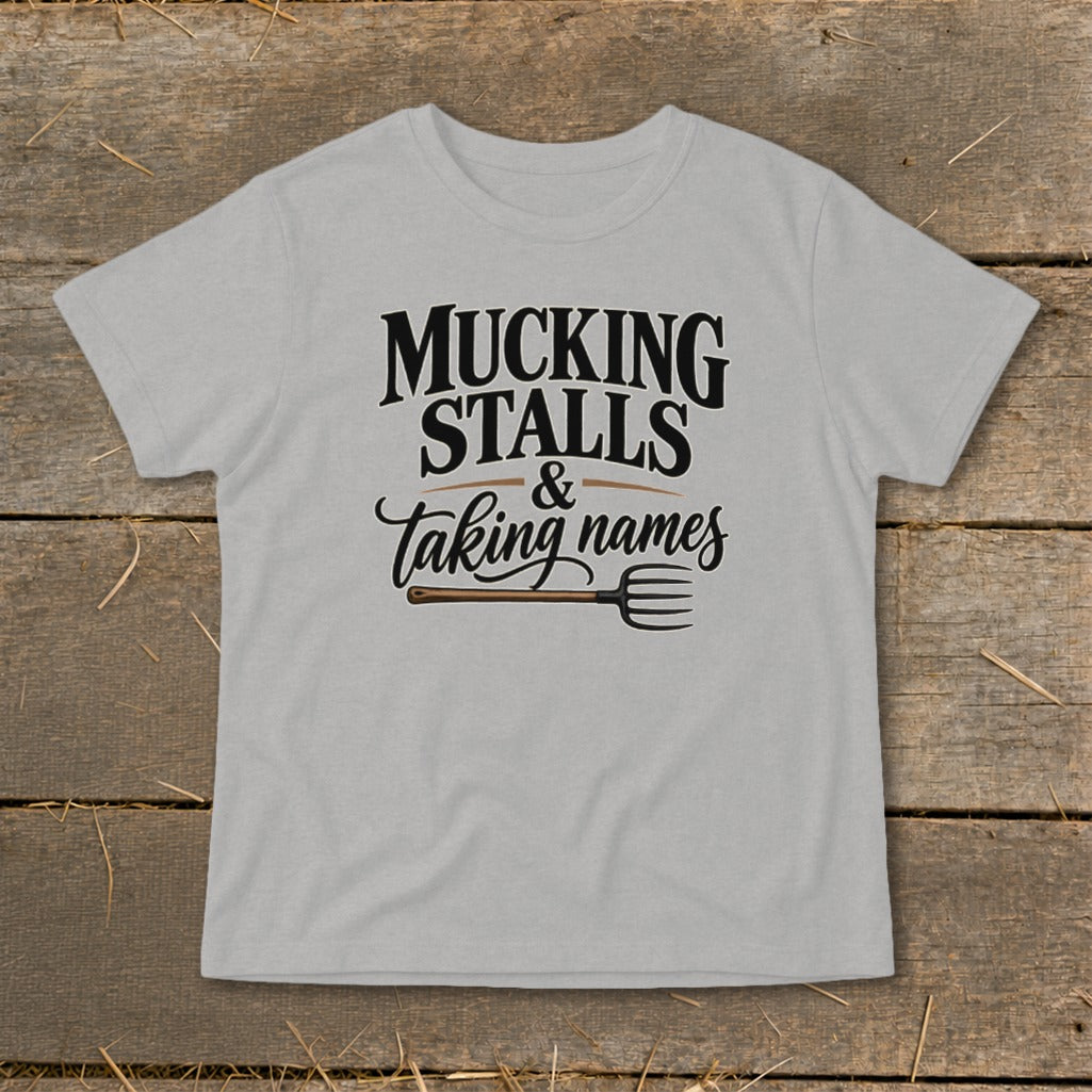 Light grey t-shirt with "Mucking Stalls & Taking Names" and a pitchfork graphic.