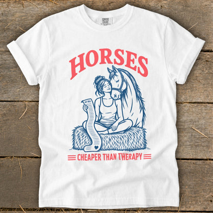 White t-shirt with "Horses Cheaper Than Therapy" text and horse and person graphic.
