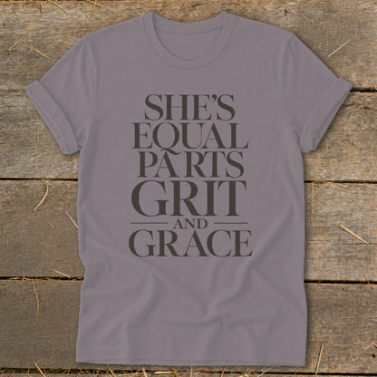 Purple t-shirt with text "SHE'S EQUAL PARTS GRIT AND GRACE".