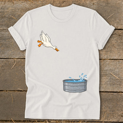 White t-shirt with cartoon goose jumping into galvanized tub of water.