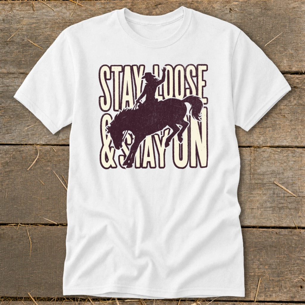 White t-shirt with a distressed graphic of a rodeo rider on a bucking horse and text.