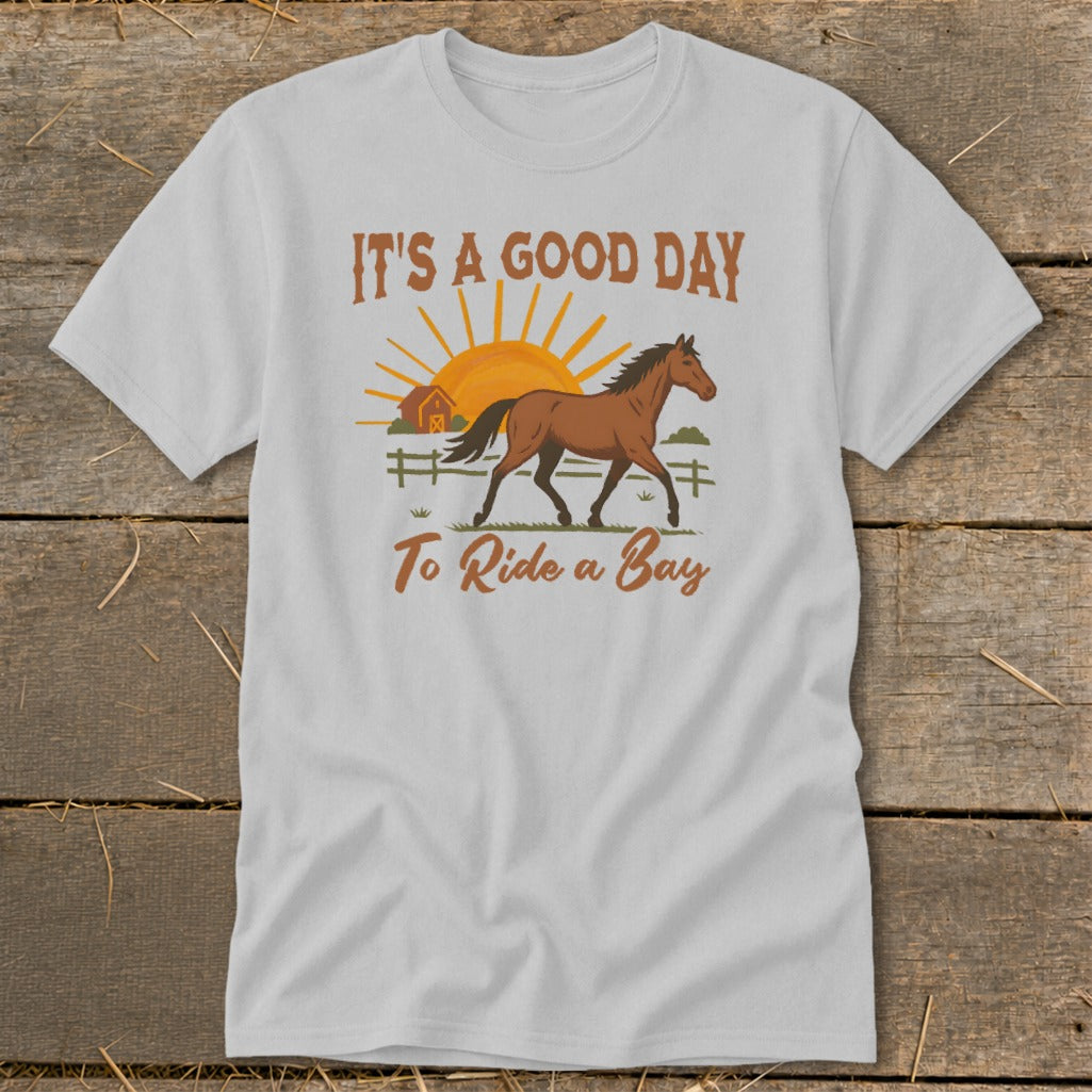 White t-shirt with a bay horse, barn, and sun graphic with text "It's a good day to ride a bay".