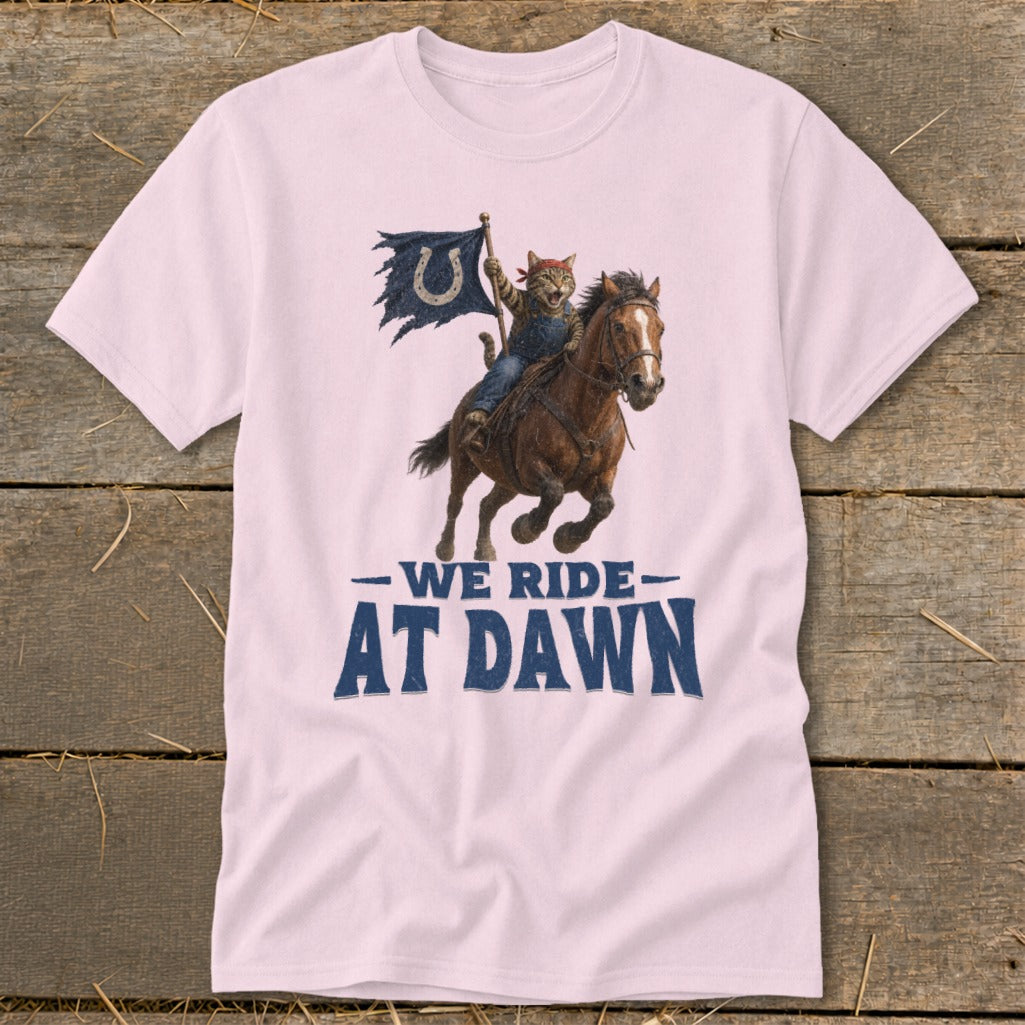 Cat cowboy rides horse holding a flag with text "WE RIDE AT DAWN".