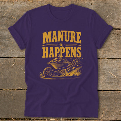 Purple t-shirt with "Manure Happens" text above a wheelbarrow full of steaming manure.