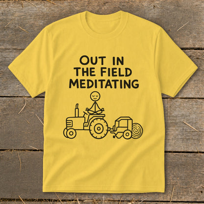 Yellow t-shirt with black text and line drawing of a tractor, person meditating, and baler.