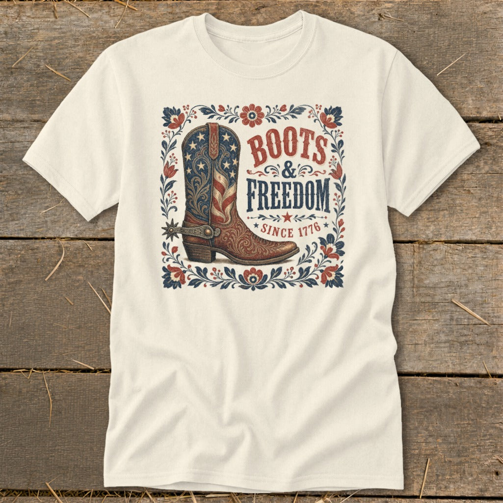 Cream t-shirt with patriotic cowboy boot graphic and text "Boots & Freedom Since 1776".