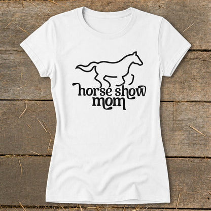 White t-shirt with black line art of a running horse and text "horse show mom."