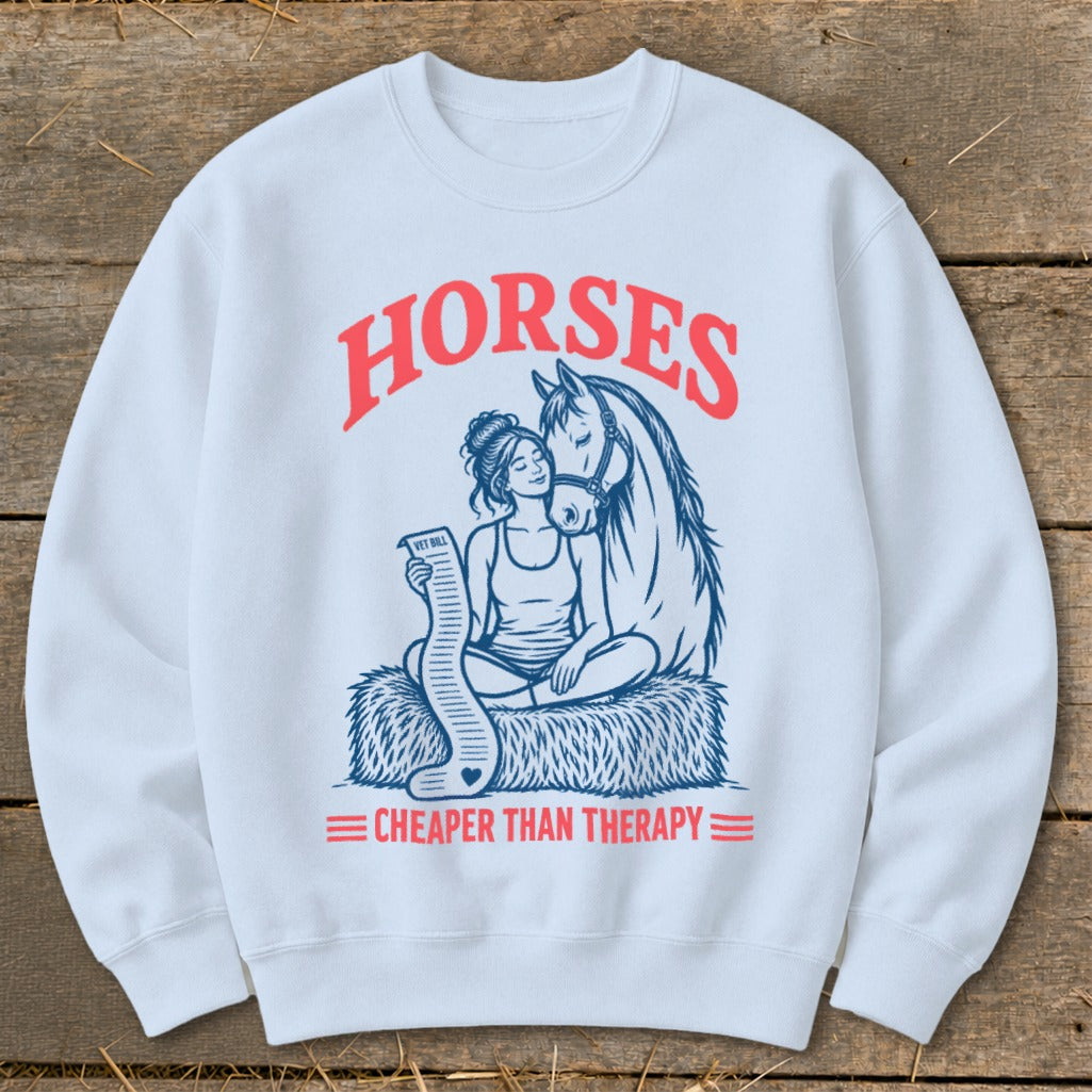 White sweatshirt with "HORSES CHEAPER THAN THERAPY" text and horse and rider graphic.