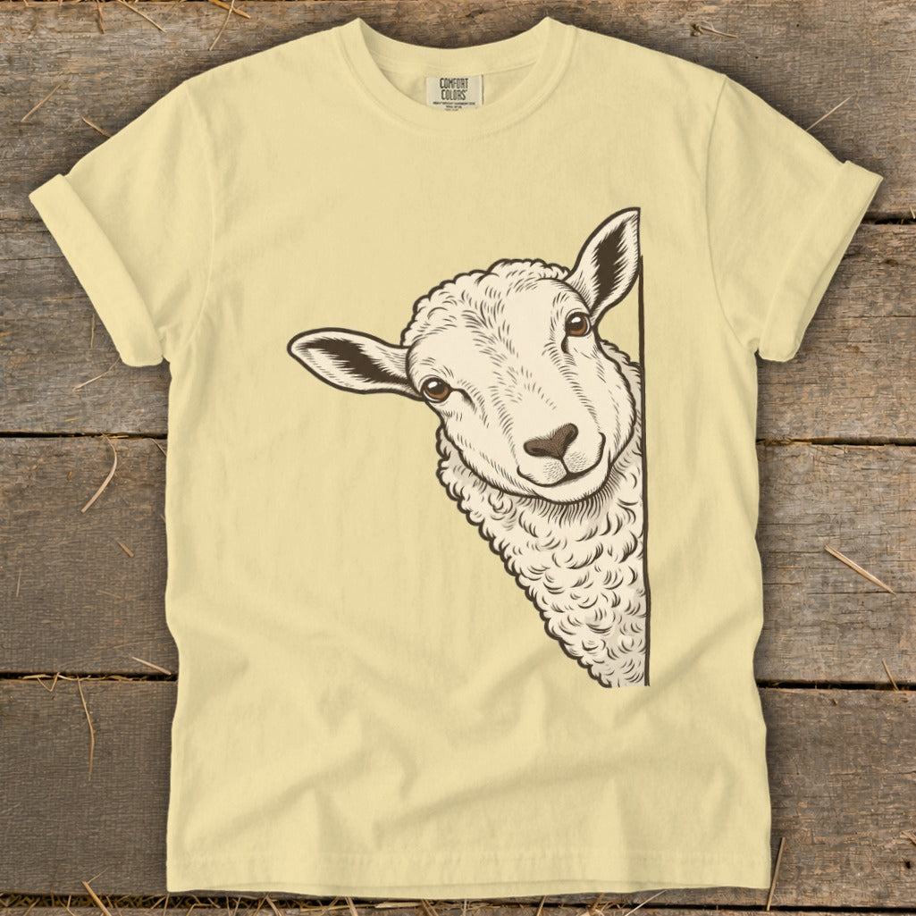 Light yellow t-shirt with a drawing of a sheep peeking from the right side.